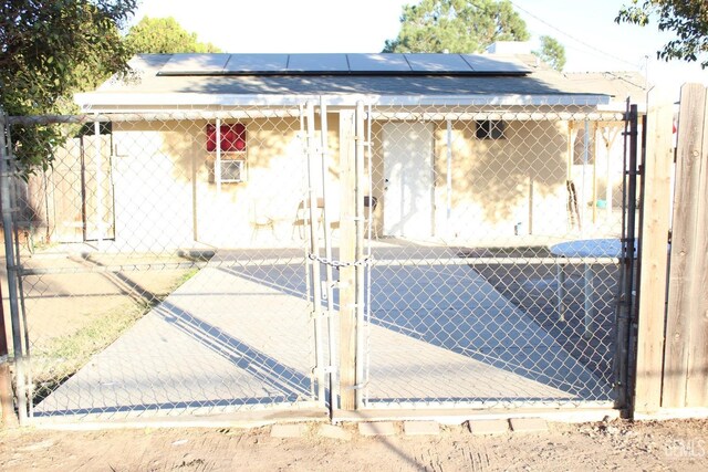 view of gate featuring solar panels