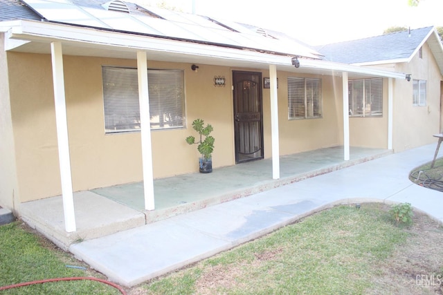 doorway to property featuring solar panels