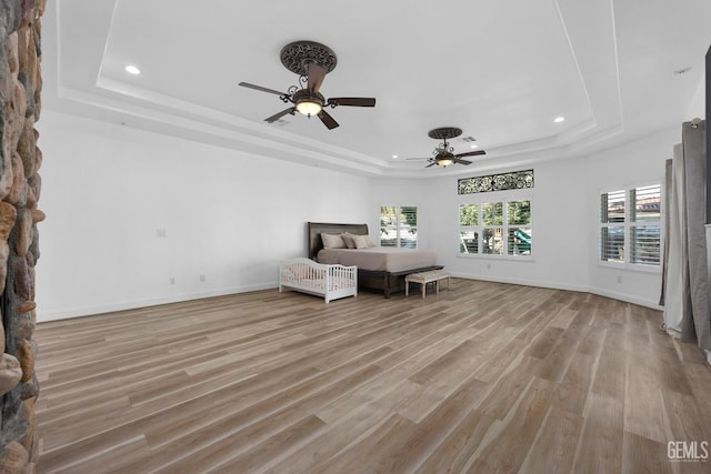 10834 Olcese Rd, Bakersfield, CA 93308 - unfurnished bedroom featuring ceiling fan, a raised ceiling, and light hardwood / wood-style flooring