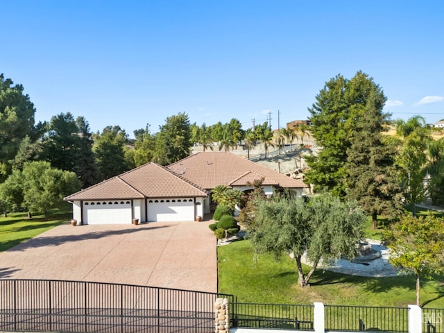 view of front of house with a garage and a front lawn