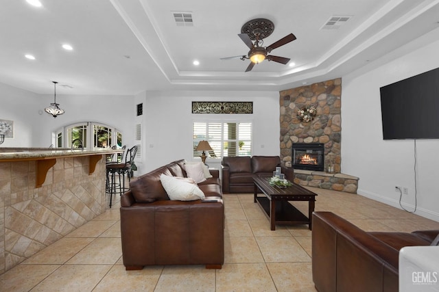 10834 Olcese Rd, Bakersfield, CA 93308 - living room featuring ceiling fan, a healthy amount of sunlight, light tile patterned floors, and a fireplace