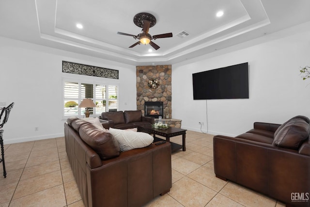 10834 Olcese Rd, Bakersfield, CA 93308 - living room with ceiling fan, light tile patterned flooring, a raised ceiling, and a fireplace