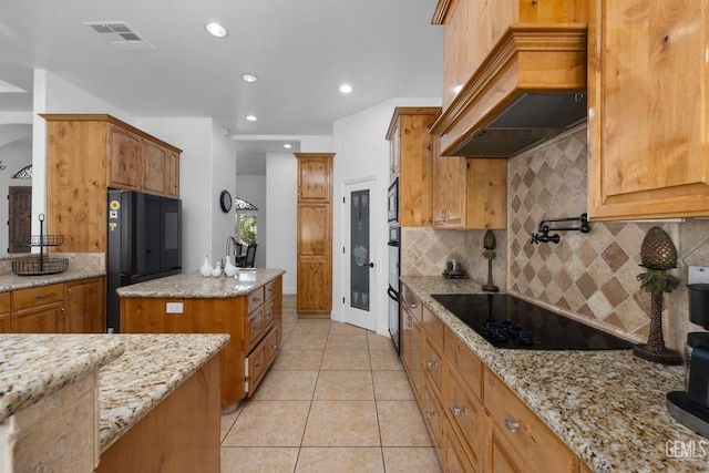 10834 Olcese Rd, Bakersfield, CA 93308 - kitchen with tasteful backsplash, light stone counters, custom exhaust hood, black appliances, and light tile patterned floors