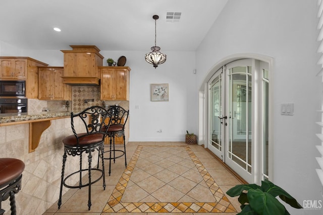 10834 Olcese Rd, Bakersfield, CA 93308 - kitchen with backsplash, french doors, black appliances, light tile patterned floors, and a breakfast bar area