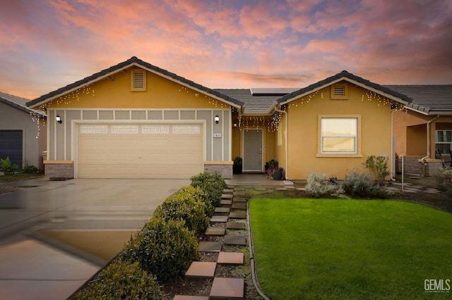 ranch-style house featuring solar panels, stucco siding, a garage, driveway, and a tiled roof