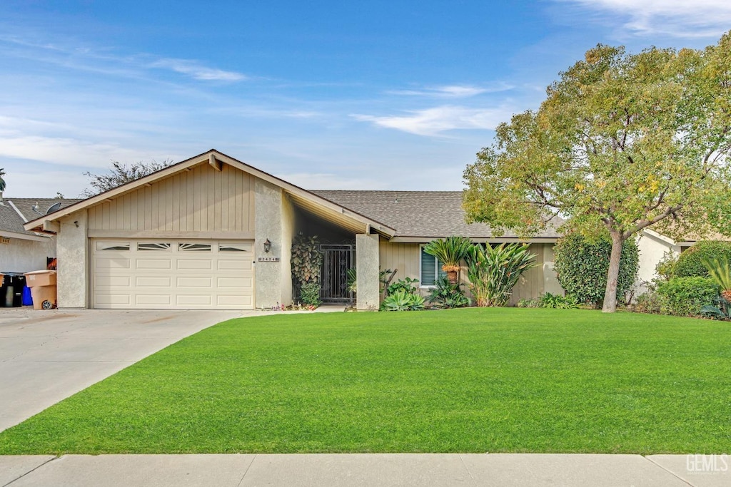 ranch-style home with a garage and a front yard