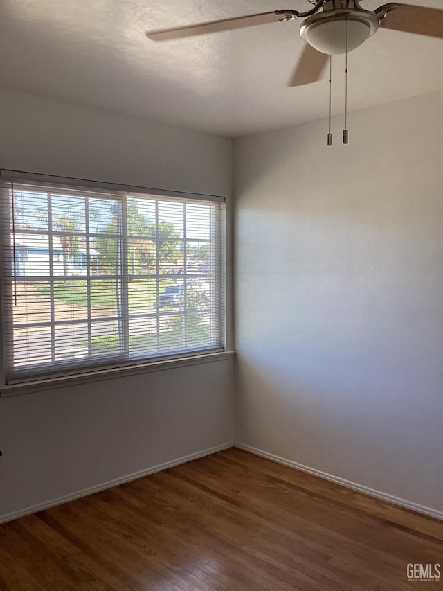 spare room with hardwood / wood-style flooring and ceiling fan