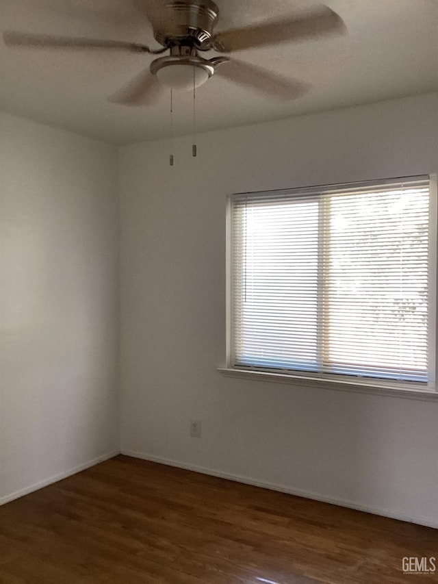 unfurnished room featuring ceiling fan and dark hardwood / wood-style floors