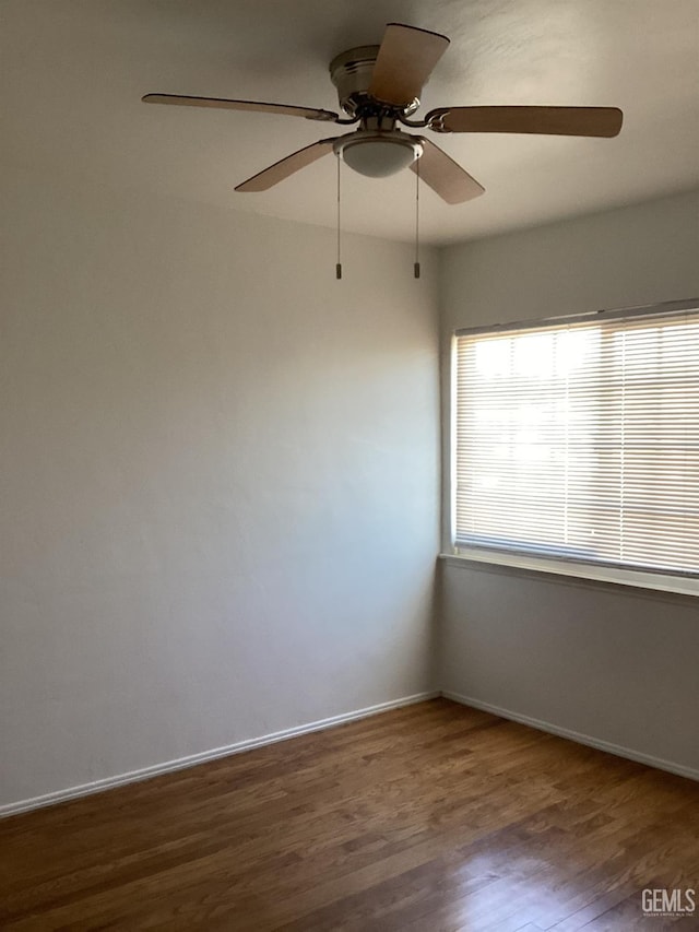 unfurnished room with ceiling fan and wood-type flooring