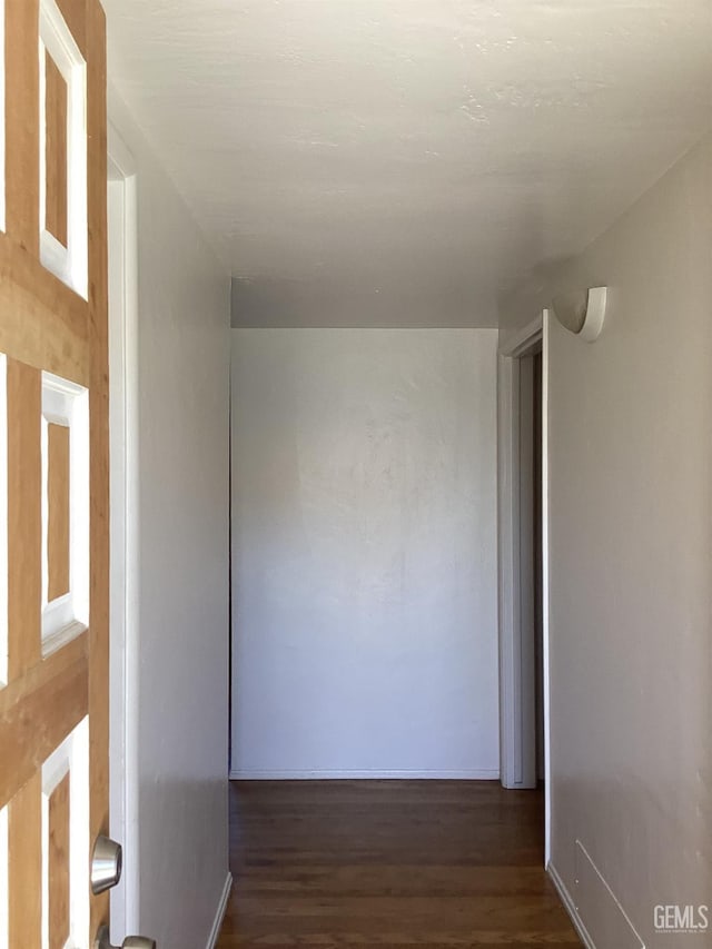 hallway with dark hardwood / wood-style flooring