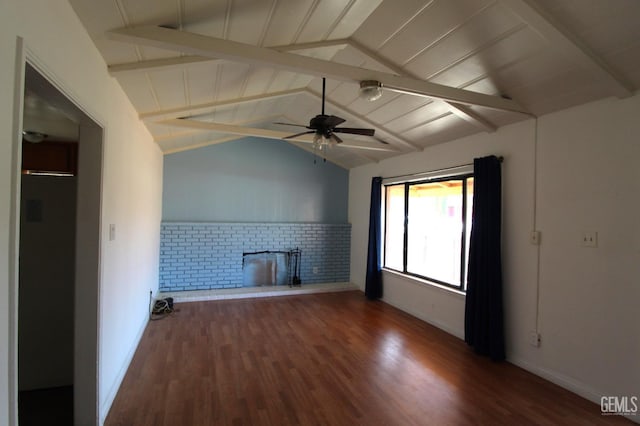 unfurnished living room with lofted ceiling with beams, a fireplace, wood finished floors, and a ceiling fan