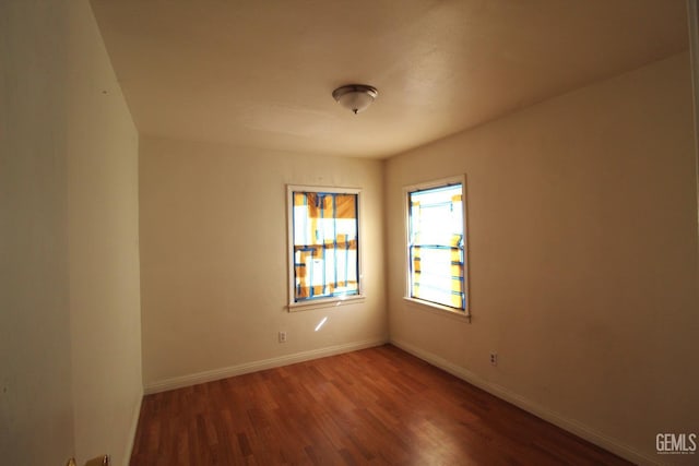 empty room with wood finished floors and baseboards