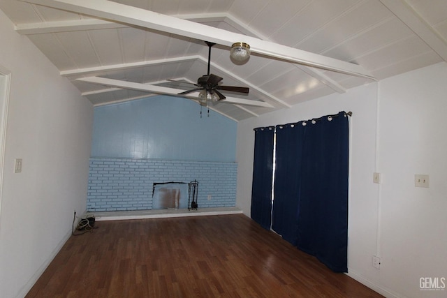 unfurnished living room with lofted ceiling with beams, ceiling fan, a brick fireplace, and dark wood finished floors