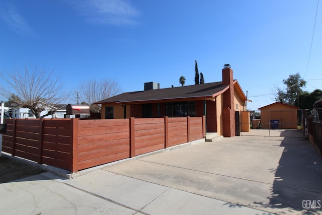 view of front of home with a chimney and fence