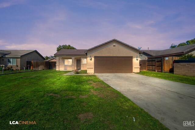 ranch-style home featuring a garage and a front yard