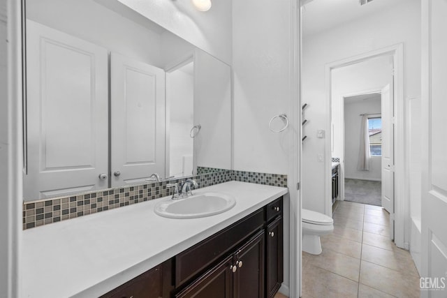 15420 Saint Clement Way, Bakersfield, CA 93314 - bathroom featuring vanity, toilet, tile patterned flooring, and decorative backsplash