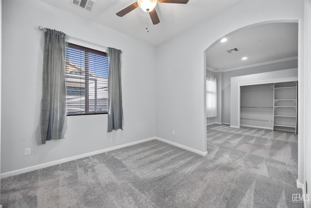 15420 Saint Clement Way, Bakersfield, CA 93314 - carpeted spare room with arched walkways, ceiling fan, baseboards, and ornamental molding