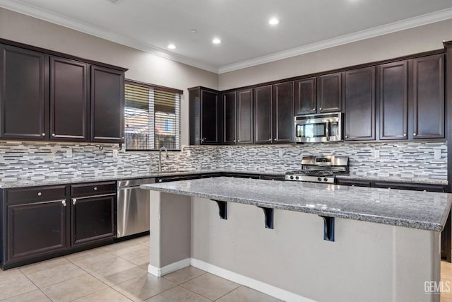 15420 Saint Clement Way, Bakersfield, CA 93314 - kitchen featuring appliances with stainless steel finishes, light tile patterned floors, a breakfast bar, a center island, and light stone counters