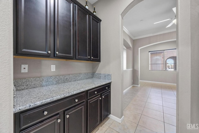 15420 Saint Clement Way, Bakersfield, CA 93314 - kitchen with arched walkways, ceiling fan, ornamental molding, light tile patterned flooring, and baseboards