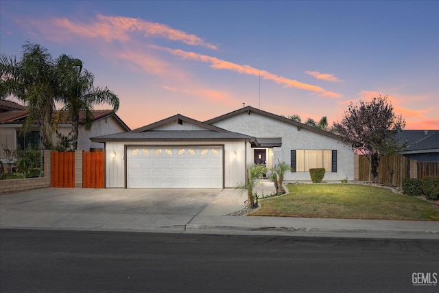 single story home with a lawn and a garage