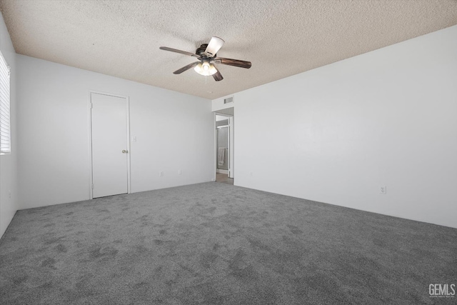 unfurnished bedroom featuring carpet, a textured ceiling, and ceiling fan