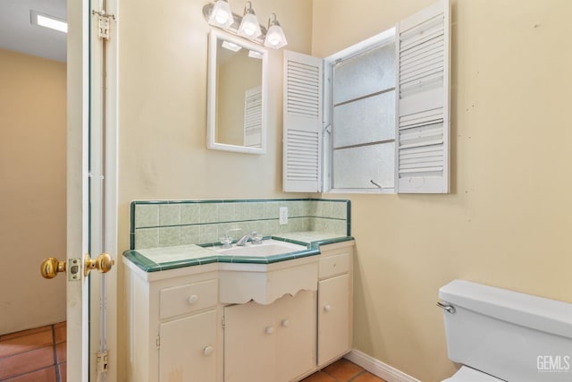 half bath with vanity, tile patterned flooring, and toilet