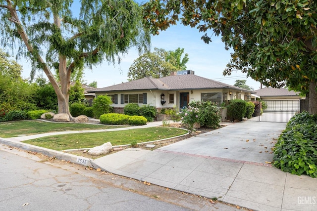 single story home with a gate and a front yard