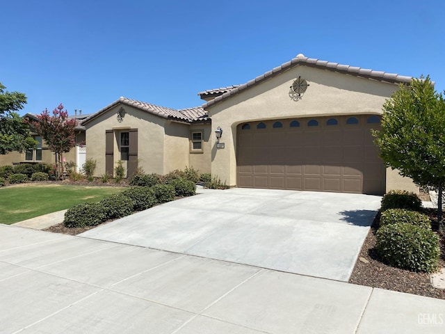 mediterranean / spanish house featuring a garage