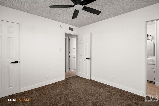 417 B St, Taft, CA 93268 - unfurnished bedroom featuring a textured ceiling, carpet floors, ensuite bath, and a ceiling fan