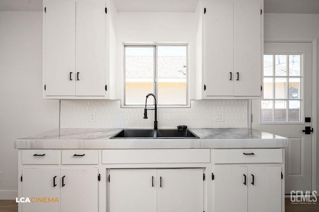 417 B St, Taft, CA 93268 - kitchen featuring white cabinets, tasteful backsplash, and light countertops