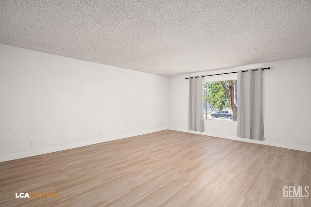 417 B St, Taft, CA 93268 - unfurnished room featuring light wood-style floors and a textured ceiling
