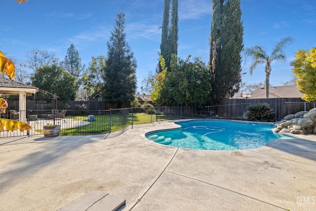 view of swimming pool featuring a yard, a fenced in pool, a fenced backyard, and a patio