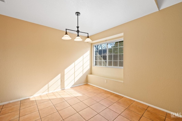 unfurnished room with visible vents, baseboards, and light tile patterned flooring