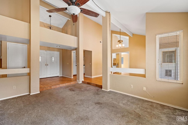 unfurnished living room with carpet flooring, ceiling fan, high vaulted ceiling, beamed ceiling, and baseboards