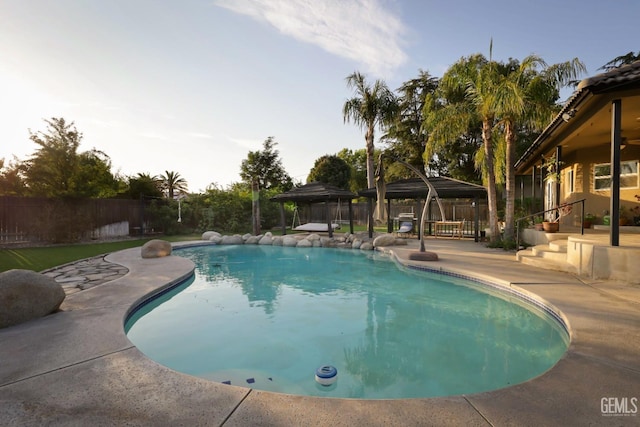 view of swimming pool with a gazebo and a patio