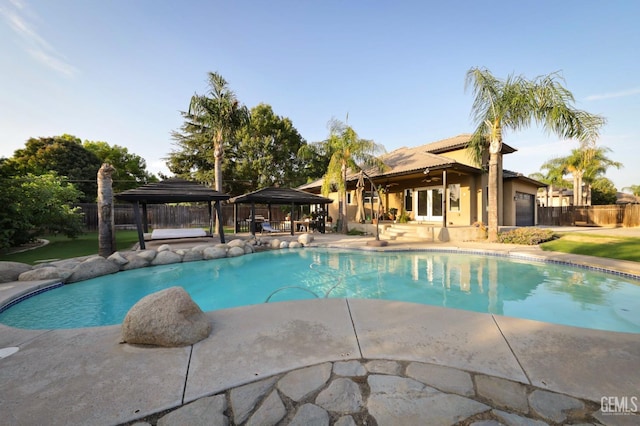 view of swimming pool with a gazebo and a patio