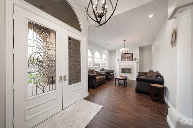 entryway featuring dark hardwood / wood-style floors, french doors, and a chandelier