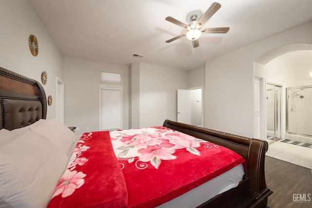 bedroom with ceiling fan, ensuite bathroom, and light hardwood / wood-style flooring