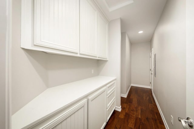 hallway with dark hardwood / wood-style flooring