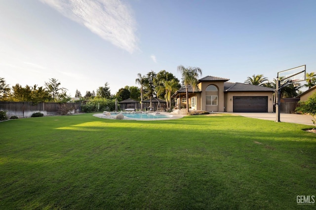 view of front of home with a fenced in pool, a gazebo, a front lawn, and a garage