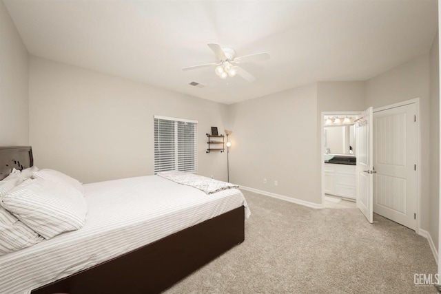 carpeted bedroom with connected bathroom and ceiling fan