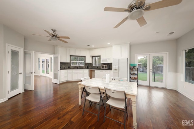 dining area featuring sink, dark wood-type flooring, a wealth of natural light, and french doors