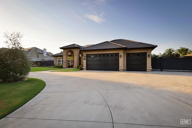 view of front of property featuring a garage and a front yard