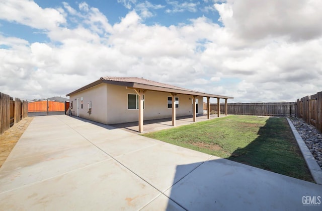 5817 Neutra Dr, Bakersfield, CA 93311 - back of property with a patio area, a fenced backyard, stucco siding, and a tiled roof