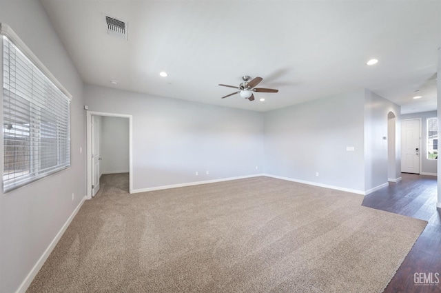5817 Neutra Dr, Bakersfield, CA 93311 - unfurnished room with arched walkways, ceiling fan, recessed lighting, dark wood-type flooring, and dark carpet