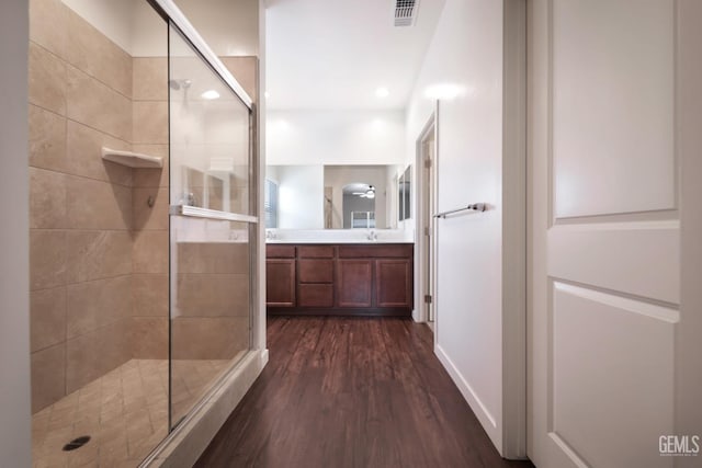 5817 Neutra Dr, Bakersfield, CA 93311 - bathroom featuring a shower stall, wood finished floors, and vanity
