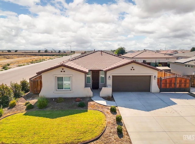5817 Neutra Dr, Bakersfield, CA 93311 - mediterranean / spanish-style home featuring stucco siding, an attached garage, concrete driveway, and a tile roof