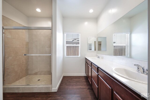 5817 Neutra Dr, Bakersfield, CA 93311 - bathroom with wood finished floors, double vanity, a stall shower, plenty of natural light, and recessed lighting
