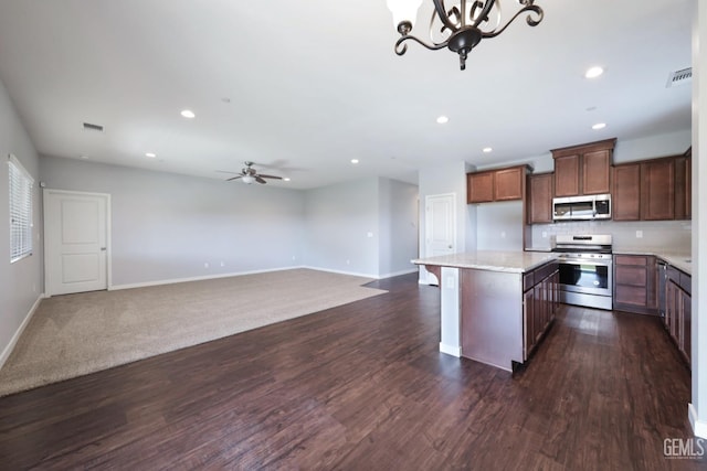 5817 Neutra Dr, Bakersfield, CA 93311 - kitchen featuring appliances with stainless steel finishes, recessed lighting, dark wood-type flooring, a center island, and a ceiling fan