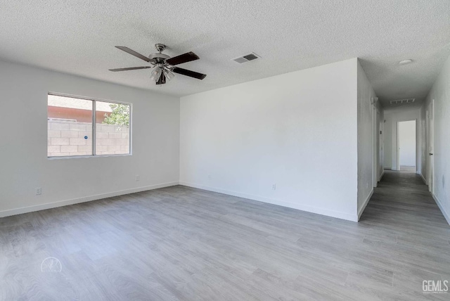 1857 Fern Tree Close, Wasco, CA 93280 - spare room featuring a ceiling fan, wood finished floors, and a textured ceiling